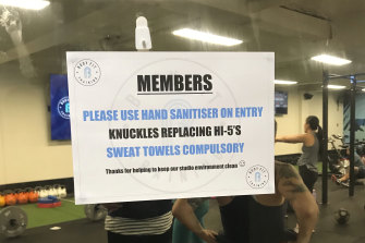 A sign on a gym door in response to coronavirus.