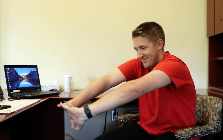 Christian Kennicott, a LIVE FOR LIFE fitness specialist, demonstrates a shoulder protraction stretch. Photo by Jonathan Black.