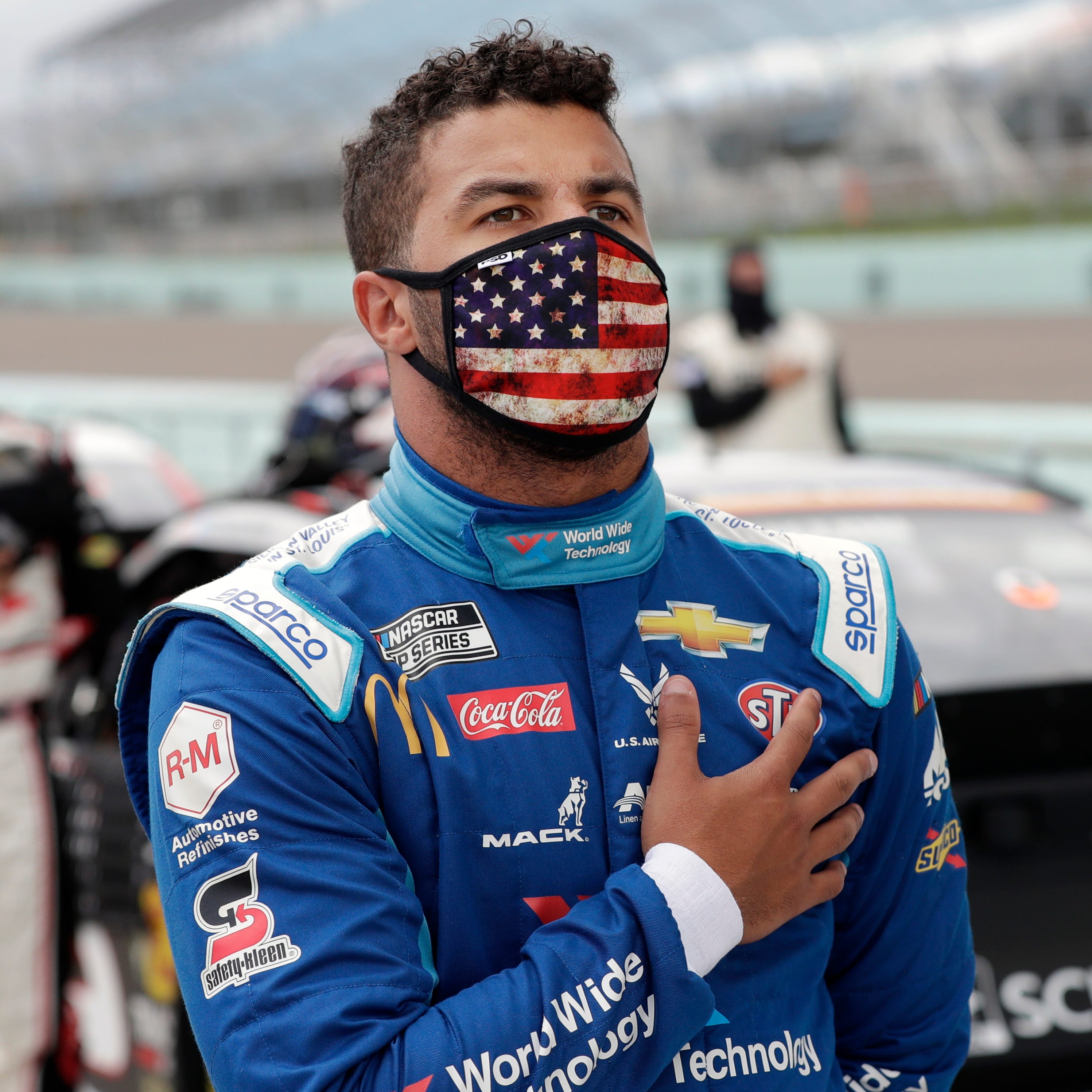 Bubba Wallace stands for the national anthem before a NASCAR Cup Series auto race Sunday, June 14, 2020, in Homestead, Fla.