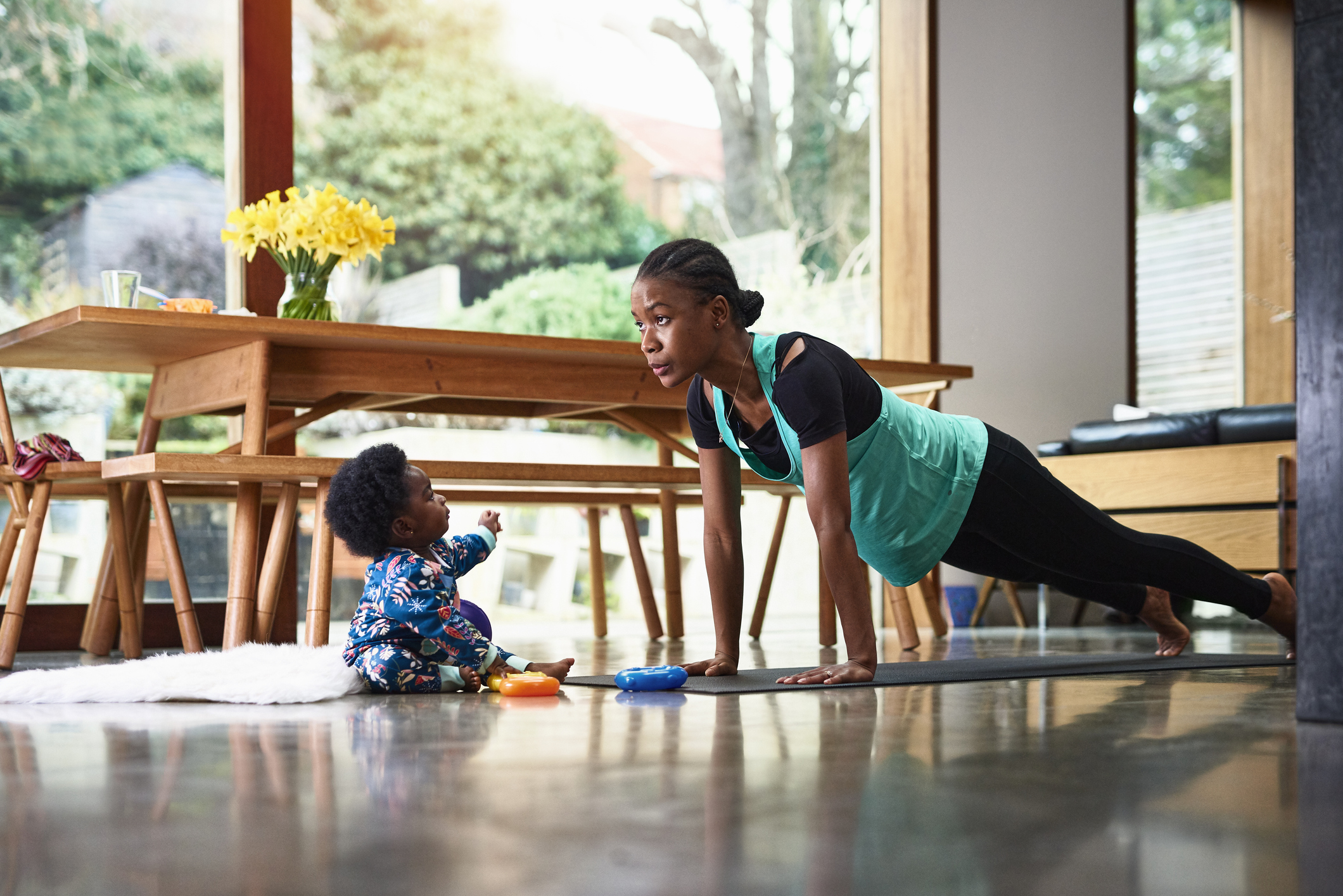 Baby boy assisting mother exercising