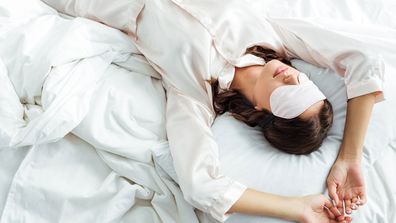 Woman sleeping with sleep mask