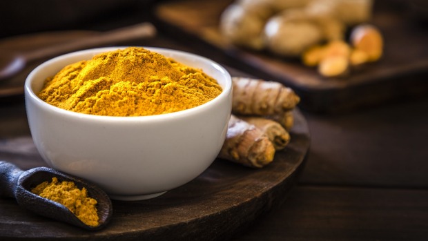 Front view of a turmeric powder bowl on a rustic wooden table. Alongside the bowl is a wooden serving scoop filled with turmeric powder and are at the left lower corner. At the right top corner is a defocussed wooden cutting boar with quinoa seeds on top. Low key DSLR photo taken with Canon EOS 6D Mark II and Canon EF 24-105 mm f/4L Turmeric
iStock
